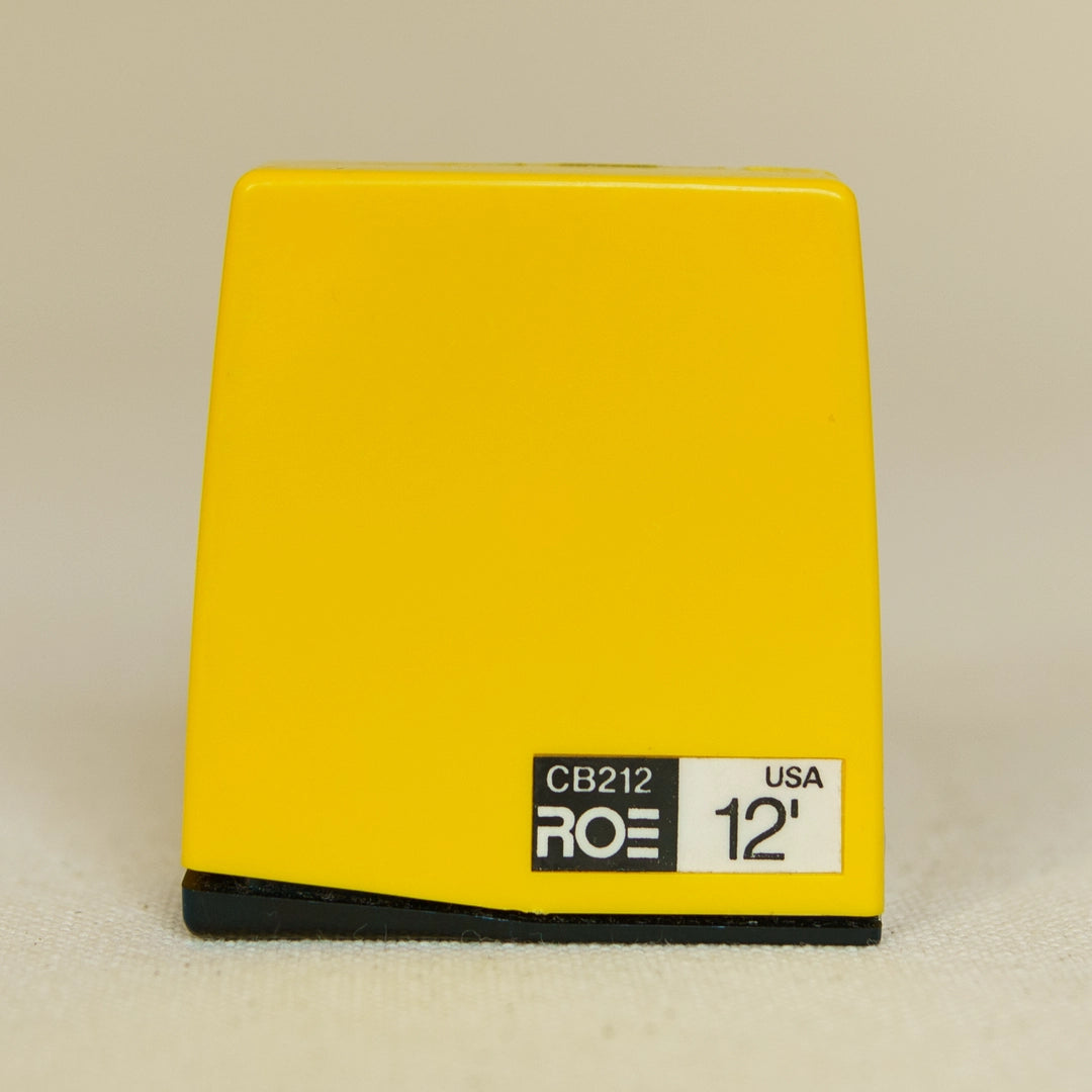 A yellow, rectangular vintage tape measure with a black base, featuring the text 'CB212', 'ROE', '12'', and 'USA' on a white label.